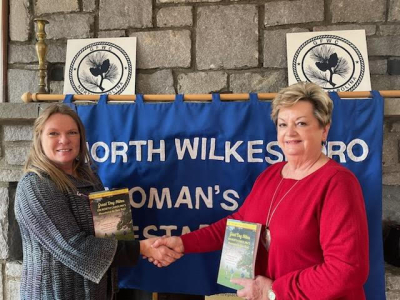 Suzanne Moore receives book donation from Sharon Guenther